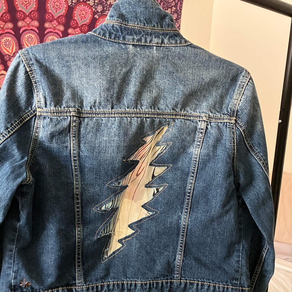 Cycled women’s jean jacket with cut out lightning bolt